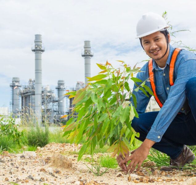 industry-worker-plant-tree-at-petroleum-building-2025-03-07-13-54-44-utc